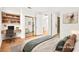 Comfortable bedroom featuring neutral decor, a built-in desk, and an ensuite bathroom with a walk in closet at 10920 Grand Haven Ave, Las Vegas, NV 89134