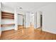 Bedroom with hardwood floors, built-in shelves, and mirrored closet doors at 10920 Grand Haven Ave, Las Vegas, NV 89134