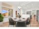 Bright and airy dining area with stylish chandelier and views of the backyard at 10920 Grand Haven Ave, Las Vegas, NV 89134