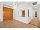 Bright entryway with double wood doors and built-in shelving at 10920 Grand Haven Ave, Las Vegas, NV 89134