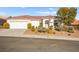 Single story home with attached garage and desert landscaping at 10920 Grand Haven Ave, Las Vegas, NV 89134