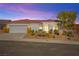 Charming single-story home with a red tile roof, desert landscaping, and a two-car garage at 10920 Grand Haven Ave, Las Vegas, NV 89134