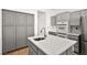 Eat-in kitchen with gray cabinets and a large island at 10920 Grand Haven Ave, Las Vegas, NV 89134