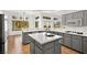 Modern kitchen with gray cabinets, island, and white countertops at 10920 Grand Haven Ave, Las Vegas, NV 89134
