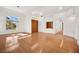 Sunlit living room with hardwood and tile floors, and large windows at 10920 Grand Haven Ave, Las Vegas, NV 89134