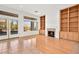 Living room with hardwood floors, tile floors, fireplace, and built-in shelves at 10920 Grand Haven Ave, Las Vegas, NV 89134