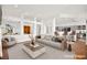 Staged living room with open layout, eat-in kitchen, neutral colors, and modern decor, perfect for entertaining at 10920 Grand Haven Ave, Las Vegas, NV 89134