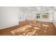 Sunlit living room with hardwood and tile floors, and backyard access at 10920 Grand Haven Ave, Las Vegas, NV 89134