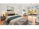 Cozy bedroom with plenty of natural light, light wood floors, and sliding doors to the backyard at 10920 Grand Haven Ave, Las Vegas, NV 89134