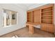 Home office with built-in wooden desk and shelving at 10920 Grand Haven Ave, Las Vegas, NV 89134