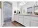 Bright bathroom with white cabinets, marble counters, and a shower/tub combo at 1140 Woodcastle St, Henderson, NV 89052