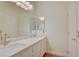 Bathroom features dual sinks, quartz countertop, large mirrors, and modern fixtures at 1140 Woodcastle St, Henderson, NV 89052