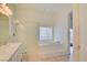 Bright bathroom featuring a glass shower and separate soaking tub at 1140 Woodcastle St, Henderson, NV 89052