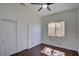 Bright bedroom features wood floors, a ceiling fan, window and closet with paneled doors at 1140 Woodcastle St, Henderson, NV 89052