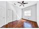 Bright bedroom with hardwood floors, a ceiling fan, and double door closet at 1140 Woodcastle St, Henderson, NV 89052