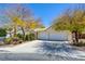 Beautiful home with a three-car garage, mature trees, and well-maintained landscaping at 1140 Woodcastle St, Henderson, NV 89052