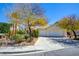 Inviting single-story home featuring a three-car garage and lovely landscaping details at 1140 Woodcastle St, Henderson, NV 89052