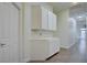 Hallway features storage cabinets with a countertop and a view down the brightly lit hall at 1140 Woodcastle St, Henderson, NV 89052