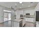 Bright kitchen featuring white cabinets, a granite island, stainless steel appliances, and sliding glass doors at 1140 Woodcastle St, Henderson, NV 89052