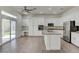 Open kitchen featuring white cabinetry, an island, stainless steel appliances, and lots of natural light at 1140 Woodcastle St, Henderson, NV 89052