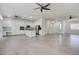 Spacious, open-concept kitchen featuring white cabinetry and stainless appliances, leading to a large living area at 1140 Woodcastle St, Henderson, NV 89052