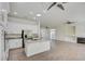 Open concept living room and kitchen featuring modern appliances, a granite island, and a cozy fireplace at 1140 Woodcastle St, Henderson, NV 89052