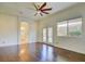 Spacious main bedroom with wood floors, ceiling fan, and bathroom access at 1140 Woodcastle St, Henderson, NV 89052
