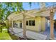 Backyard patio featuring a pergola-covered outdoor space with lush green yard and mature trees at 1140 Woodcastle St, Henderson, NV 89052