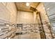 Luxurious walk-in shower featuring a rainfall shower head and mosaic tile accents at 1140 Woodcastle St, Henderson, NV 89052