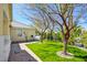 This side yard has a well-manicured lawn and paver patio, ideal for outdoor enjoyment at 1140 Woodcastle St, Henderson, NV 89052