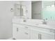 Double vanity bathroom with white cabinets and quartz countertop at 1348 Mariposa Way, Mesquite, NV 89027