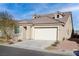 House exterior with two-car garage and desert landscaping at 1348 Mariposa Way, Mesquite, NV 89027
