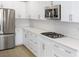 Modern kitchen with white cabinets, stainless steel appliances, and quartz countertops at 1348 Mariposa Way, Mesquite, NV 89027