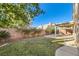 Landscaped backyard with grassy area and covered patio at 1506 Camino Summit Ave, Henderson, NV 89012