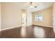 Large bedroom with dark laminate flooring, window, and access to bathroom at 1506 Camino Summit Ave, Henderson, NV 89012