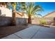 Private backyard with paved patio and mature palm trees at 1664 Britannia Ave, Henderson, NV 89014