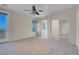 Bright bedroom featuring carpet, ceiling fan, and private balcony at 1736 Hill Canyon Ln, Las Vegas, NV 89144