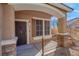 Inviting front porch with a decorative iron railing and stone accents at 1736 Hill Canyon Ln, Las Vegas, NV 89144