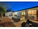 Relaxing backyard patio with seating and view of the home's interior at 1976 Caballero Way, Las Vegas, NV 89169