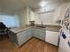 Kitchen features granite countertops, light blue cabinets, and wood flooring at 2200 S Fort Apache Rd # 1207, Las Vegas, NV 89117