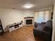 Living room with corner fireplace, wood-look floors and patio access at 2200 S Fort Apache Rd # 1207, Las Vegas, NV 89117