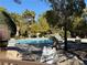 Community pool with surrounding trees and landscaping at 2200 S Fort Apache Rd # 1207, Las Vegas, NV 89117