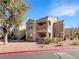 Two-story condo building with a landscaped yard and parking at 2300 E Silverado Ranch Blvd # 1136, Las Vegas, NV 89183