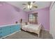 Charming bedroom with light purple walls, a ceiling fan, and a dresser at 341 Oak Canyon Dr, Henderson, NV 89015