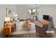 Virtually staged living room with modern furniture and wood-look floors at 3615 American Pie Ct, Las Vegas, NV 89129
