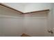 Empty closet with wood shelving and rod at 4412 Meadowbloom Ave, North Las Vegas, NV 89085