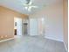 Main bedroom with tile floors, ceiling fan, and access to bathroom and closet at 5044 Droubay Dr, Las Vegas, NV 89122