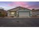 Cute stucco house with 1-car garage, desert landscaping, and neutral color palette at 5044 Droubay Dr, Las Vegas, NV 89122
