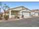 Tan and teal house exterior with 1-car garage and mature desert landscaping at 5044 Droubay Dr, Las Vegas, NV 89122