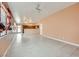 Spacious living room with tile floors and ceiling fan, open to kitchen at 5044 Droubay Dr, Las Vegas, NV 89122